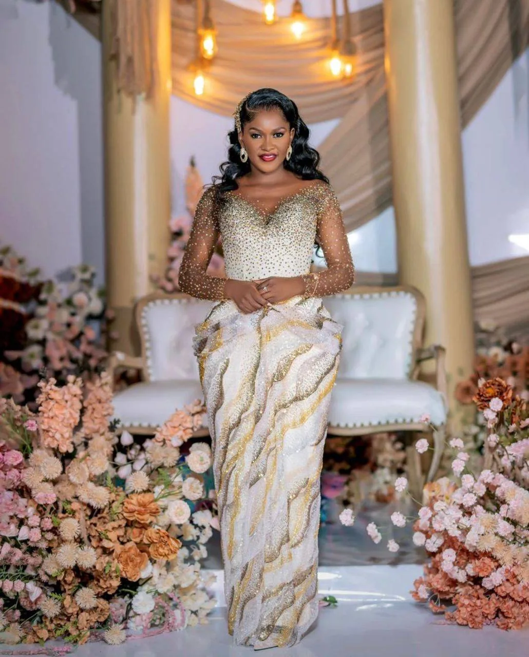 Elegant Ugandan bride in a white and gold bridal look